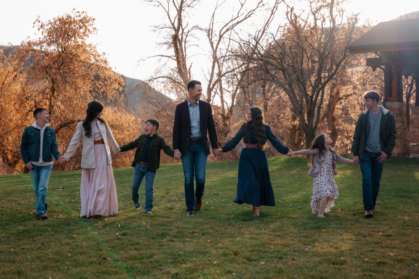 Julie and Phil Erickson walking hand in hand with their five children